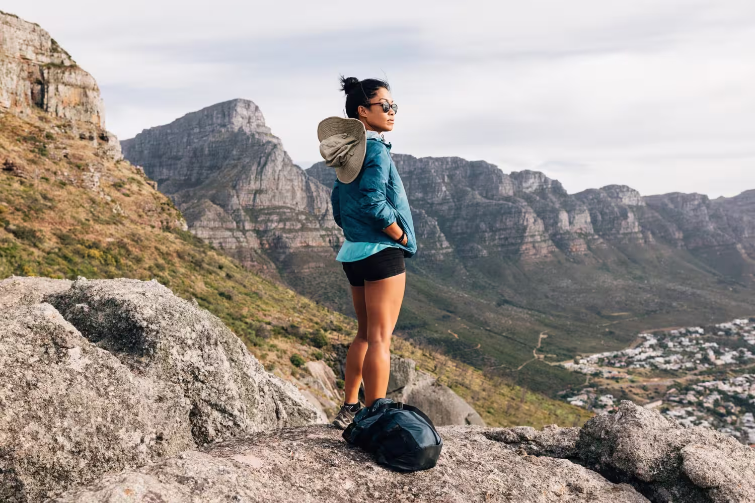 Woman on mountain trail; reflects exclusive outdoor fitness, mindfulness, and high social status.